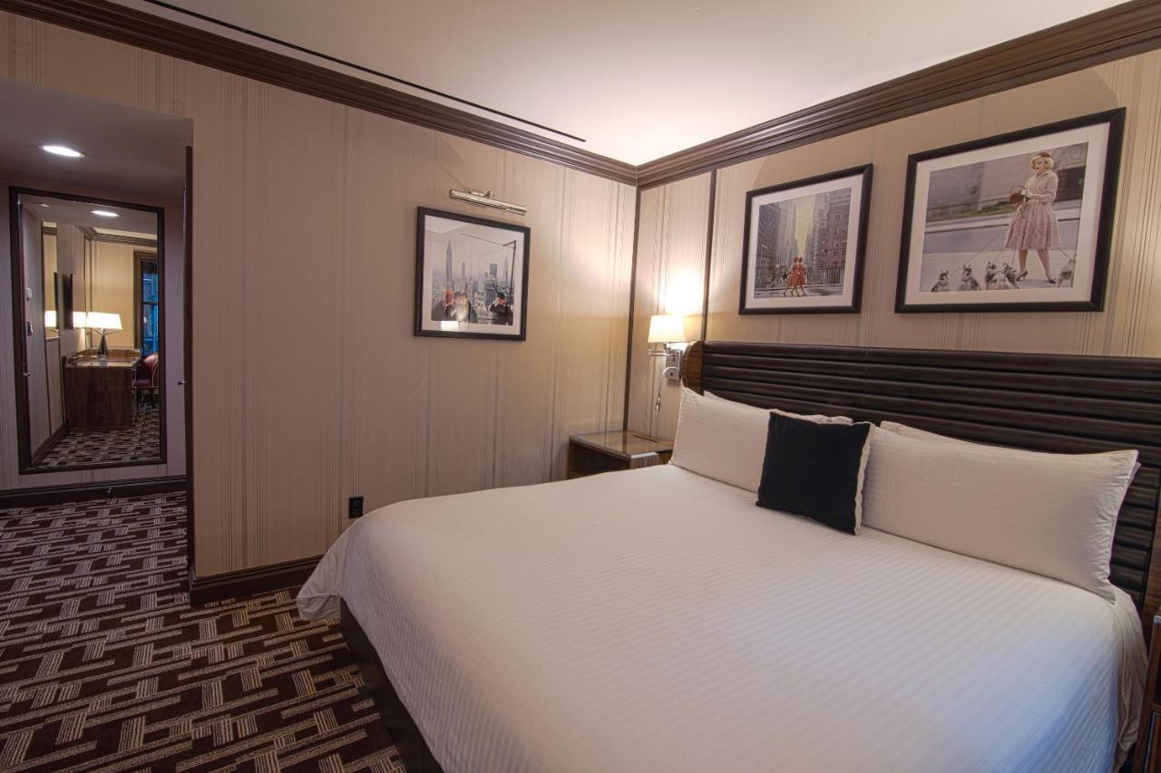 Iroquois New York Times Square Hotel Exterior photo A bedroom in a suite at the Mandarin Oriental, London